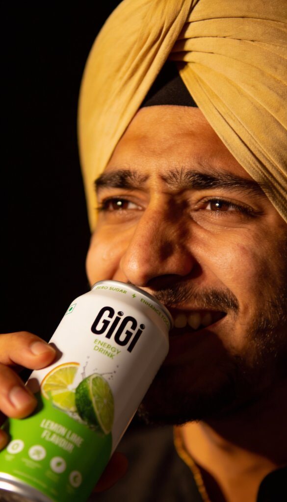 Person drinking a cold can of Gigi